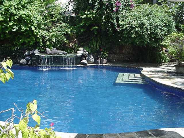 The pool boasts a beautiful tropical waterfall: Click to enlarge